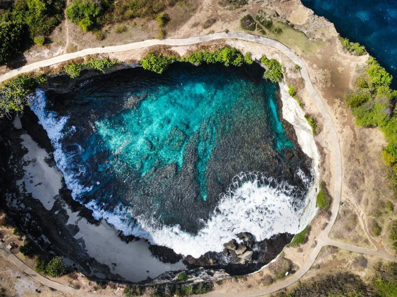 Aerial_PhotO_of_Hole_Near_Sea_With_Clear_Body_Of_Water